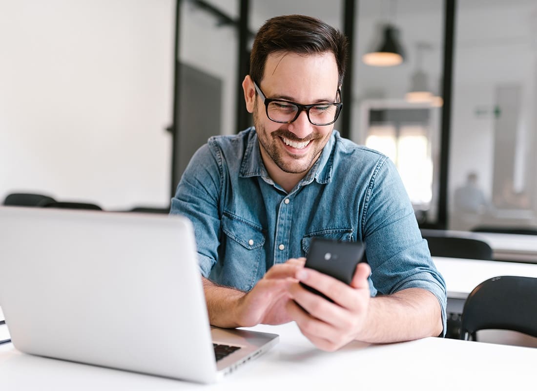 Read Our Reviews - Cheerful Man Looking at His Phone
