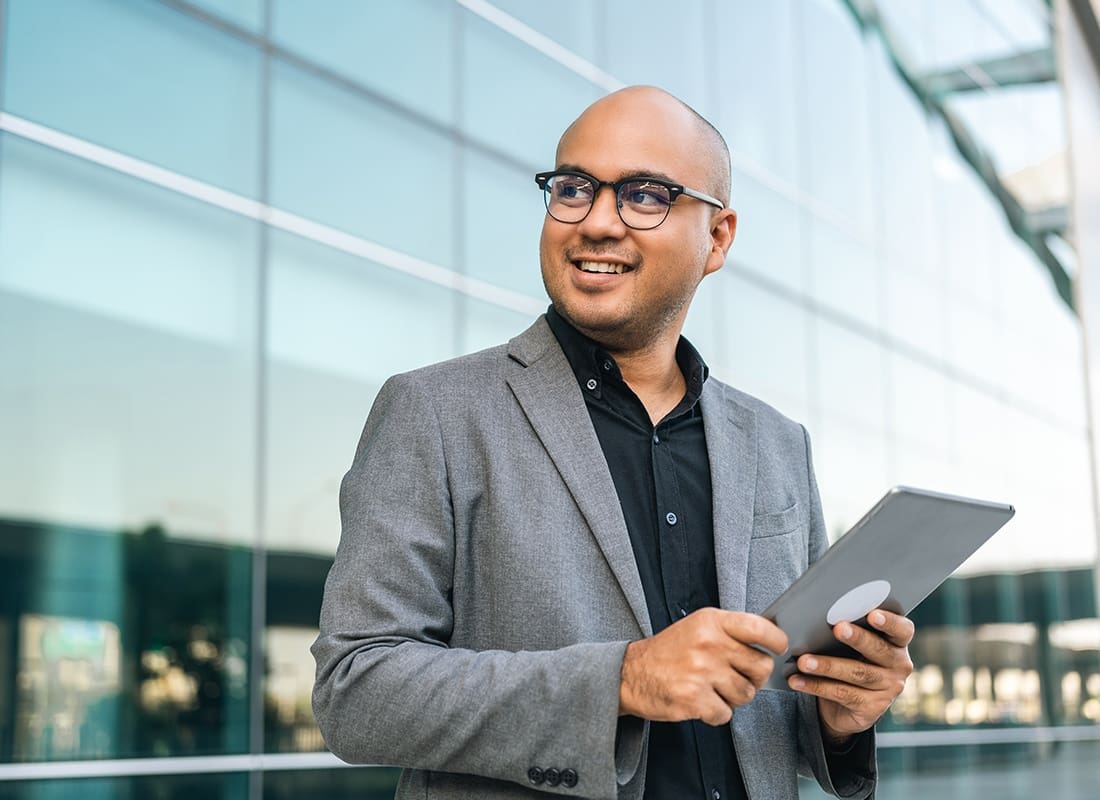 Service Center - Business Man in Suit With Tablet at the Buildings Downtown